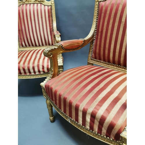 322 - Pair of carved giltwood and upholstered arm chairs in the French style {108 cm H x 56 cm W x 56 cm D... 