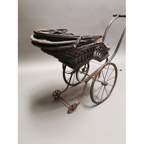 401 - 20th C. wrought iron and wicker dolls pram {70 cm H x 92 cm W x 36 cm D}.