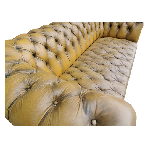 410A - Good quality hand died leather deep buttoned Chesterfield sofa on turned legs and brass castors {70 ... 