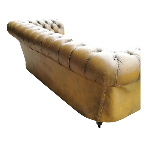 410A - Good quality hand died leather deep buttoned Chesterfield sofa on turned legs and brass castors {70 ... 
