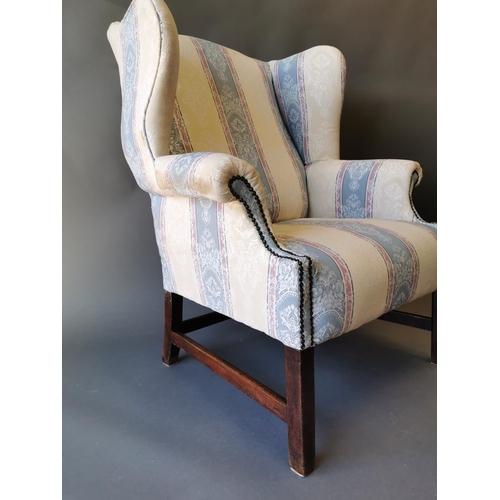 411 - Georgian mahogany and upholstered wing back arm chair on square legs {100 cm H x 79 cm W x 83 cm D}.