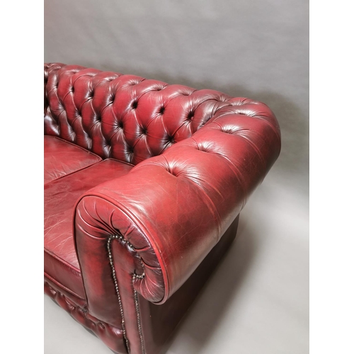 413 - Good quality oxblood leather deep buttoned two seater Chesterfield sofa {66 cm H x 161 cm W x 85 cm ... 