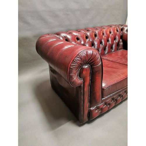 413 - Good quality oxblood leather deep buttoned two seater Chesterfield sofa {66 cm H x 161 cm W x 85 cm ... 