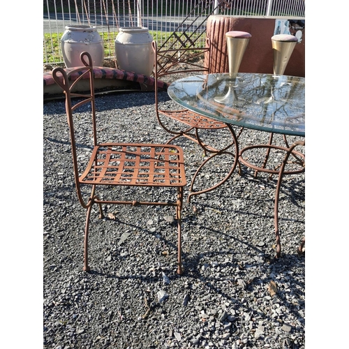 463 - Wrought iron garden table with glass top and four matching garden chairs {table is 69 cm H x 122 cm ... 