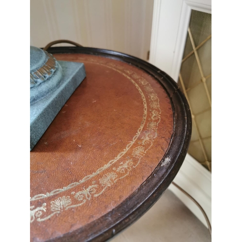 488 - Mahogany wine table, with inset tooled leather top,  above a turned column and  three outswept legs,... 