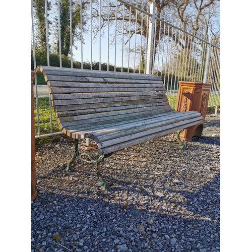 458 - Decorative cast iron and wooden garden bench {74 cm H x 140 cm W x 67 cm D}.