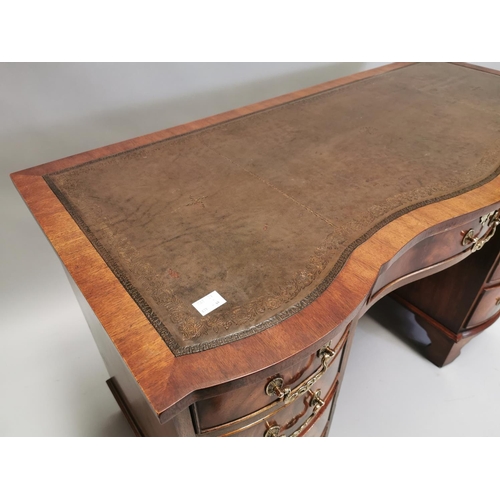 100 - Edwardian mahogany writing desk, with inset tooled leather top above a centre drawer flanked by eigh... 