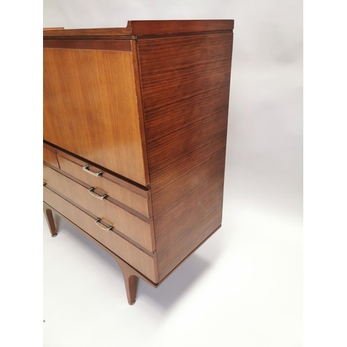 108 - Teak cocktail cabinet, the fall front above two short drawers and two long drawers raised on tapered... 
