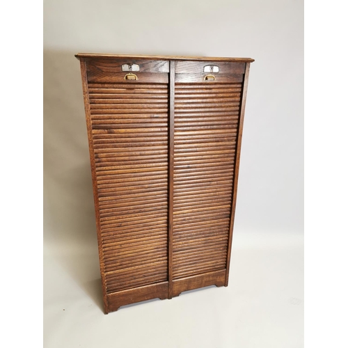 77 - Early 20th. C. oak filing cabinet, the tambour doors enclosed shelves. { 146cm H X 87cm W X 36cm D }... 
