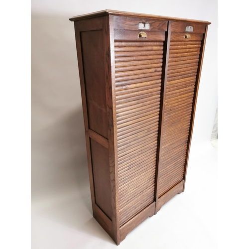 77 - Early 20th. C. oak filing cabinet, the tambour doors enclosed shelves. { 146cm H X 87cm W X 36cm D }... 