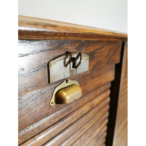 77 - Early 20th. C. oak filing cabinet, the tambour doors enclosed shelves. { 146cm H X 87cm W X 36cm D }... 