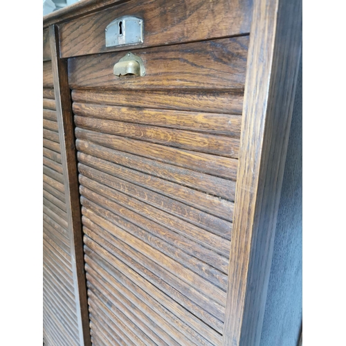 77 - Early 20th. C. oak filing cabinet, the tambour doors enclosed shelves. { 146cm H X 87cm W X 36cm D }... 