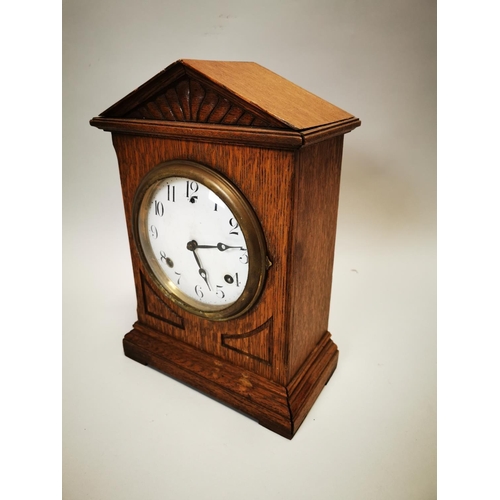 106 - Edwardian oak mantle clock with enamel dial. {36 cm h x 26 cm w x 12 cm D}.
