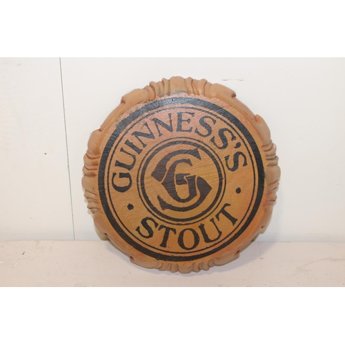 636 - Guinness Stout wooden advertising sign {30 cm Dia. x 4 cm D}.