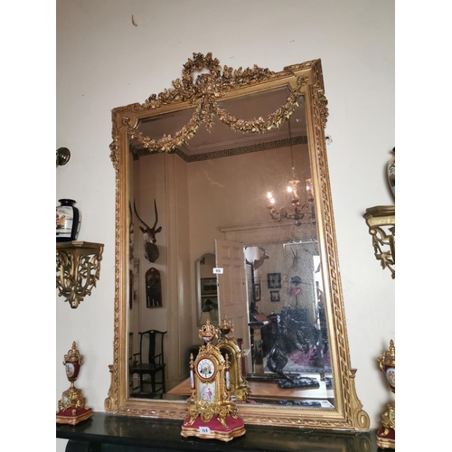 115 - Good quality 19th. C. giltwood overmantle decorated with swags and foliage { 174cm H X 122cm W }.