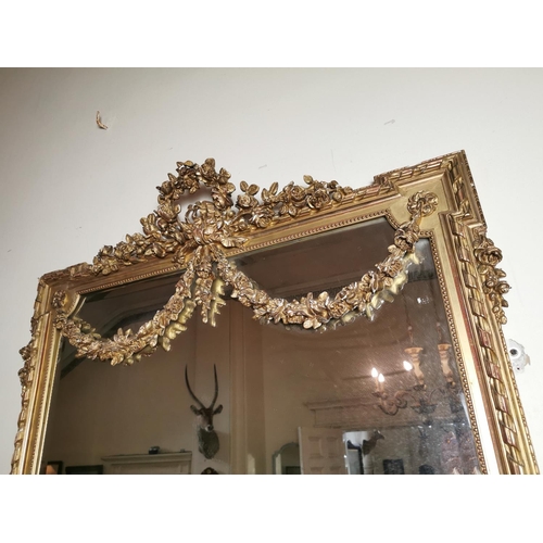 115 - Good quality 19th. C. giltwood overmantle decorated with swags and foliage { 174cm H X 122cm W }.