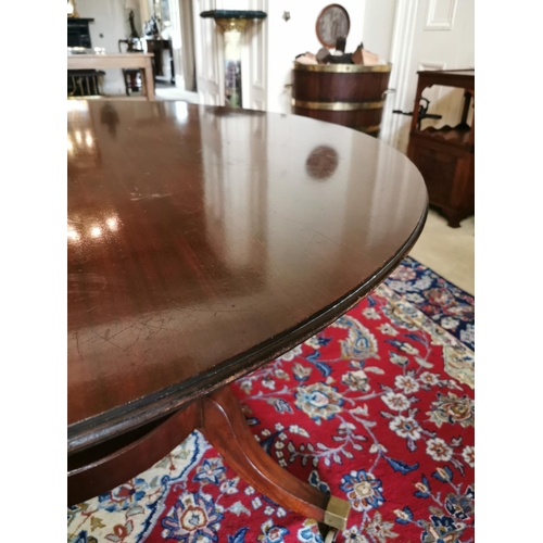 94 - Georgian mahogany breakfast table raised on four tapered columns on circular base and four outswept ... 