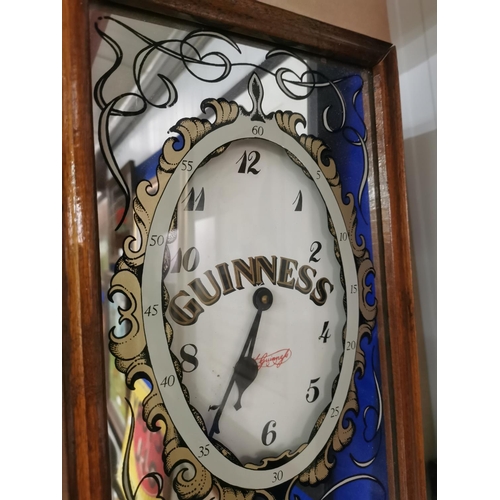 68 - Guinness Extra Stout mirrored advertising clock with wooden case. {53 cm h x 27 cm W x 9 cm D}