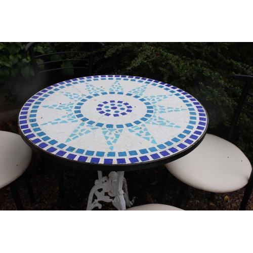 17 - Garden table with mosaic top raised on cast iron base with four metal and leather upholstered chairs... 