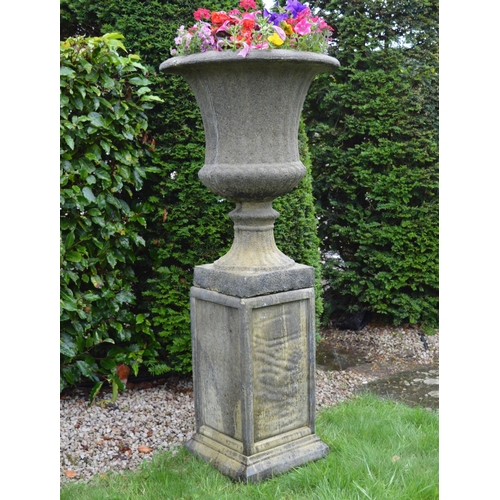 24 - Pair of stone campana garden urns on matching plinths. { 136 cm H x 59 cm W}.