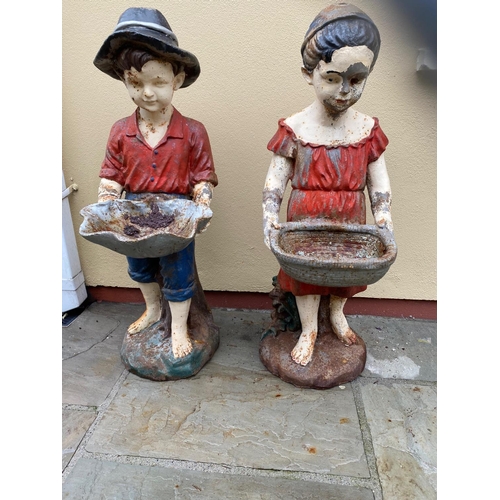 51 - Pair of cast iron figures of Boy and Girl holding baskets {98 cm H}.
