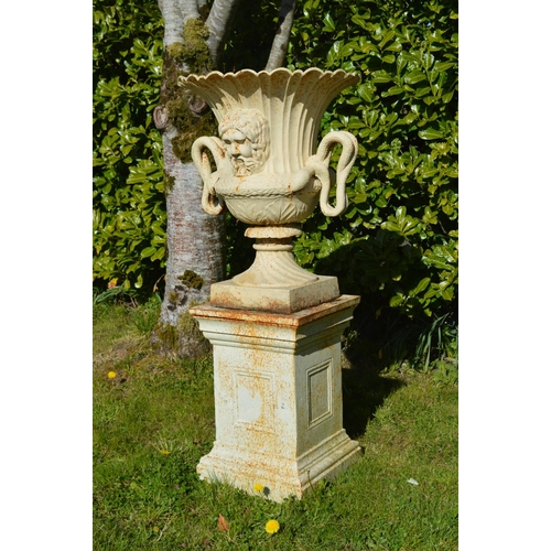 54 - Pair of cast iron urns with mask decoration and serpent handles on matching bases. {200 cm H x 62 cm... 