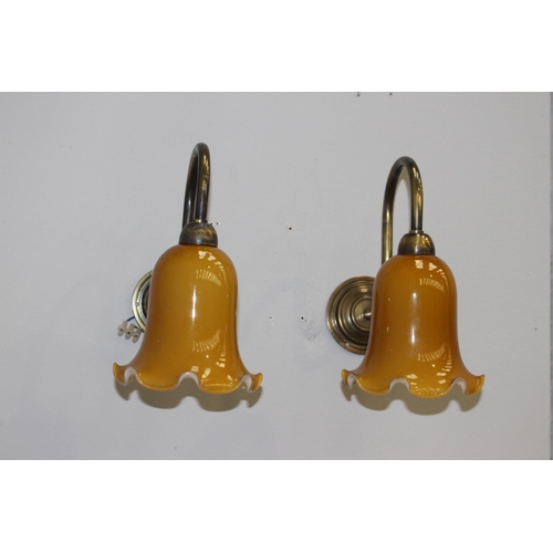 122 - Pair of brass wall lights with gold tulip shades {27 cm H x 15 cm W x 35 cm D}.