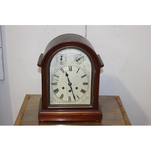 158 - Dome shaped mahogany cased clock {37 cm  H x 28 cm W x 17 cm D}.