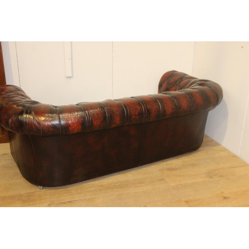 174 - Deep buttoned leather upholstered three seater Chesterfield sofa {72 cm H x 210 cm W x 98 cm D}.