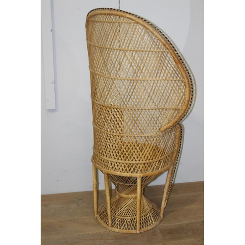 179 - Rattan armchair {137 cm H x 85 cm W x 50 cm D}.