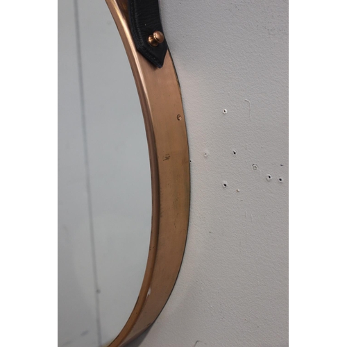 180 - Copper framed mirror with hanging leather strap {76 cm Dia. X 5 cm D}.