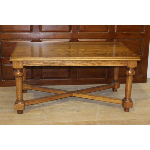 181 - Oak coffee table raised on turned legs {59 cm H x 120 cm W x 67 cm D}.