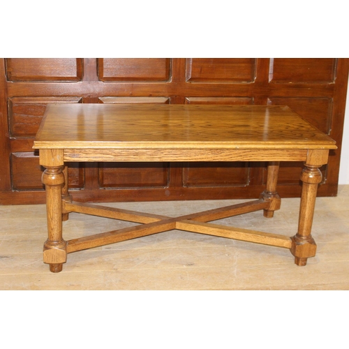 182 - Oak coffee table raised on turned legs {59 cm H x 120 cm W x 67 cm D}.