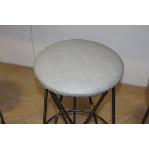 188 - Set of four metal and leather upholstered stools {79 cm H x 39 cm Dia.}.