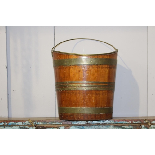 191 - Teak and brass bound oyster coal bucket {34 cm H x 33 cm W x 26 cm D}.