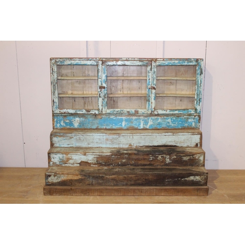 192 - Painted wood stepped three door glass cabinet {125 cm H x 153 cm W x 62 cm D}.