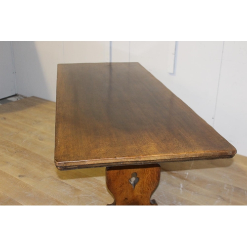 199 - Oak refectory table raised on shaped supports with single stretcher {75 cm H x 198 cm W x 80 cm D}.