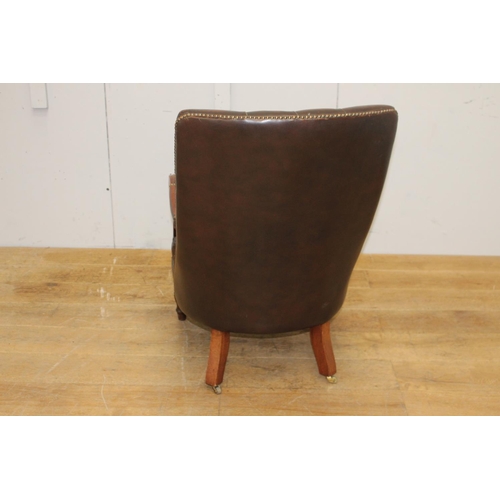 259 - Mahogany deep buttoned brown leather upholstered armchair raised on brass castors {96 cm H x 94 cm W... 