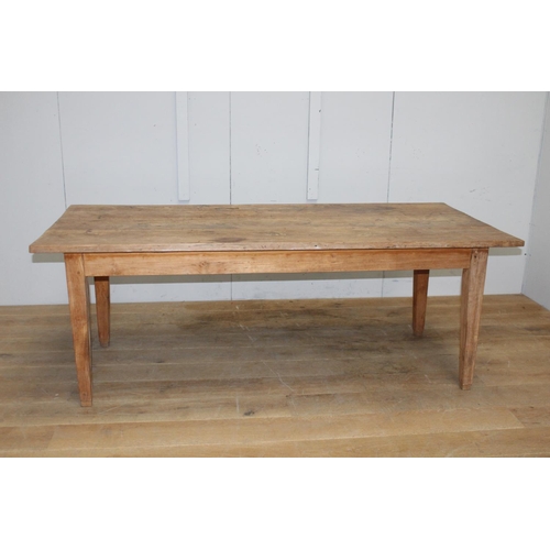 271 - Pine farmhouse table raised on square tapered legs {72 cm H x 199 cm W x 89 cm D}.