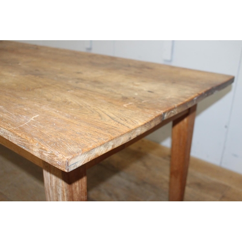 271 - Pine farmhouse table raised on square tapered legs {72 cm H x 199 cm W x 89 cm D}.