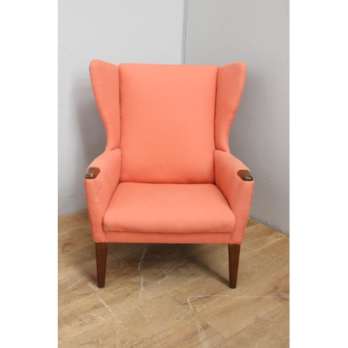 317 - Retro upholstered wing back chair raised on tapered legs {86 cm H x 79 cm W x 48 cm d}.