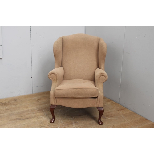 320 - Upholstered wing back armchair in the Queen Anne style {125 cm H x 72 cm W x 52 cm D}.