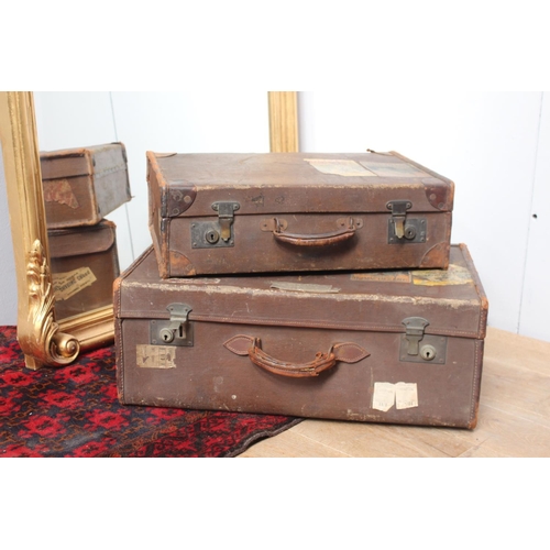 326 - Set of two garduated leather travel suitcases {25 cm H x 56 cm W x 35 cm D}.