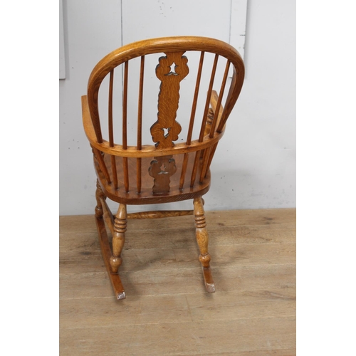 347 - Oak Windsor rocking chair {100 cm H x 53 cm W x 40 cm D}.