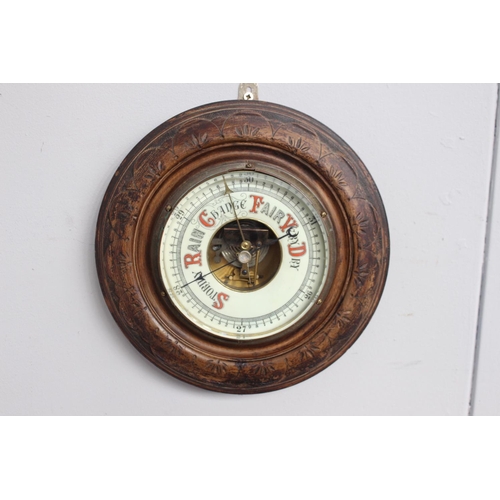 350 - Edwardian carved oak barometer with ceramic dial {30 cm Dia.}.