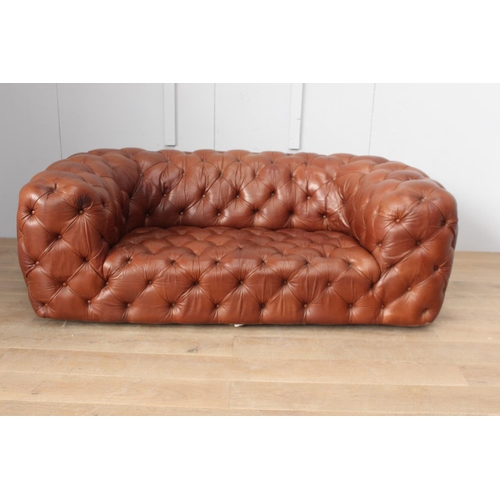36 - Deep buttoned leather upholstered Chesterfield sofa {70 cm H x 200 cm W x 65 cm D}.