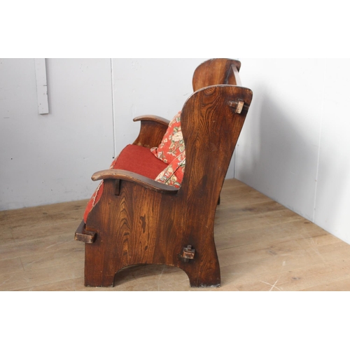 360 - Irish oak settle bench with carved arms and upholstered cushions {102 cm H x 137 cm W}.