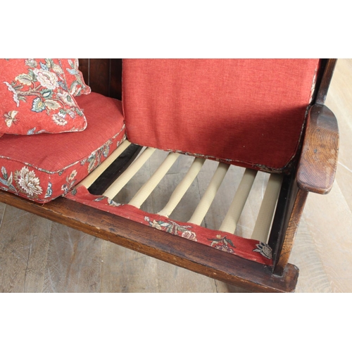 360 - Irish oak settle bench with carved arms and upholstered cushions {102 cm H x 137 cm W}.