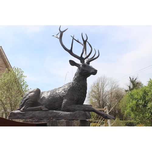 364 - Pair of bronze models of seated Stags {190 cm H x 200 cm W x 60 cm D}.