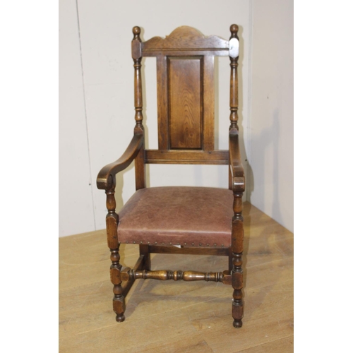 59 - Oak and brown leather upholstered armchair {120 cm H x 57 cm W x 47 cm D}.